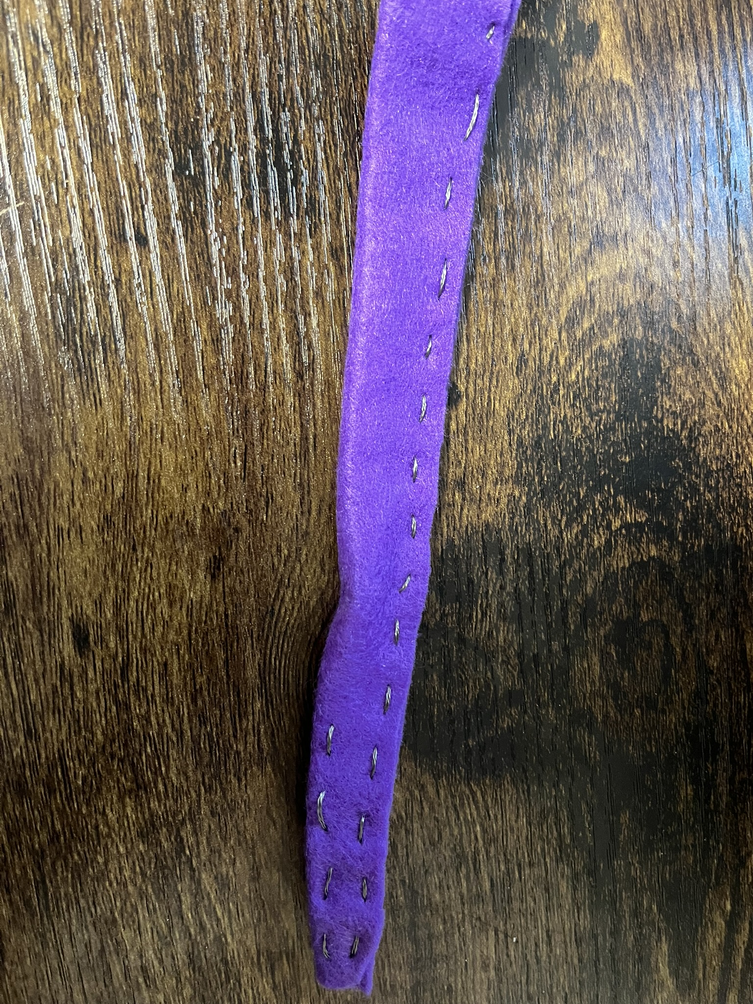 I sewed a pattern into this piece of felt with conductive thread but it ultimately did not work, not helped by the fact I forgot to sew a light in.